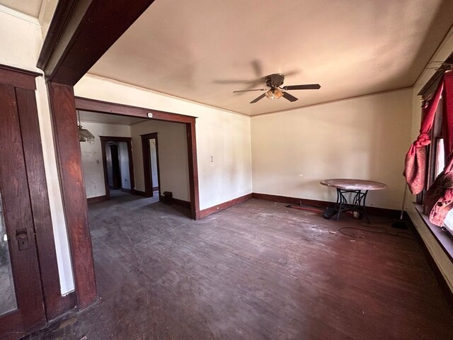 spare room featuring baseboards and a ceiling fan
