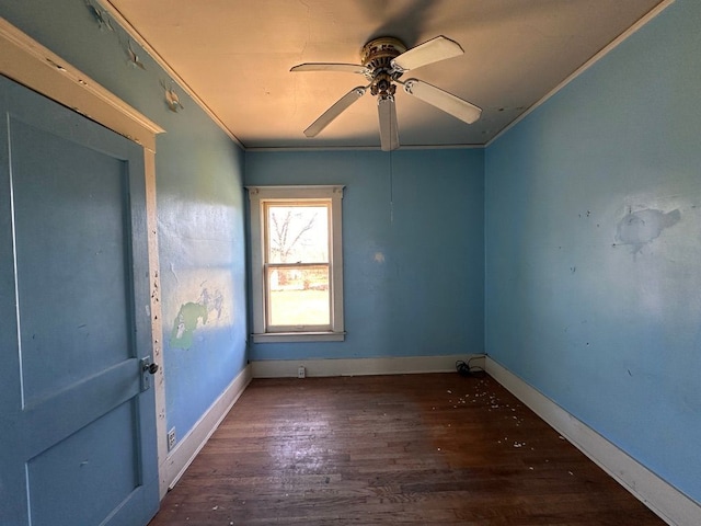 unfurnished room featuring baseboards, ornamental molding, a ceiling fan, and wood finished floors