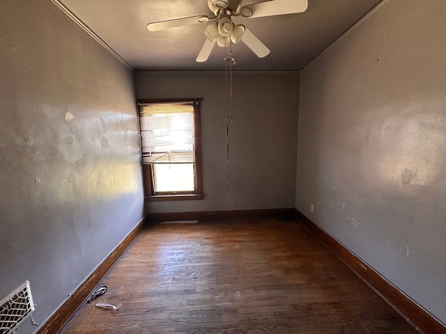 unfurnished room with baseboards, a ceiling fan, wood finished floors, and visible vents