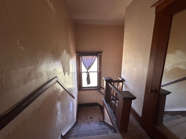 stairway featuring baseboards