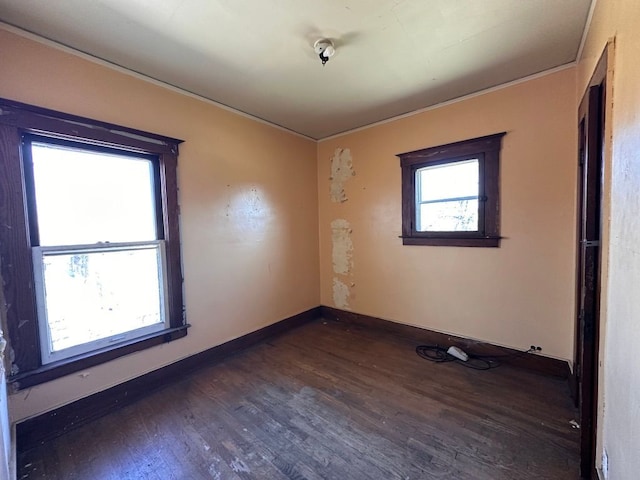 empty room featuring baseboards and wood finished floors