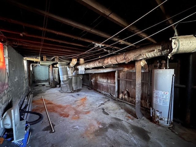 unfinished basement featuring gas water heater