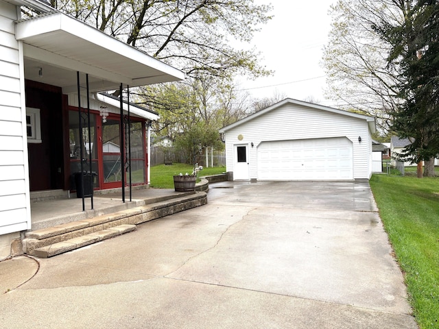 exterior space with a garage and an outbuilding