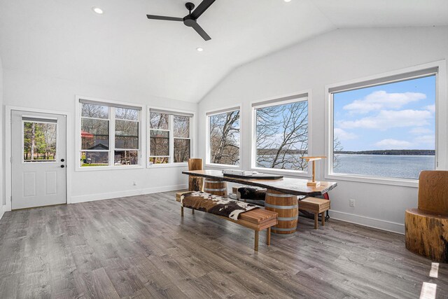 sunroom featuring a water view