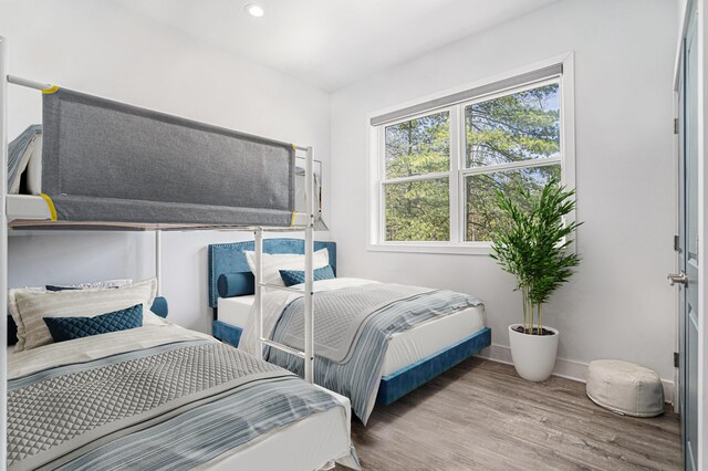 bedroom featuring baseboards, recessed lighting, and wood finished floors