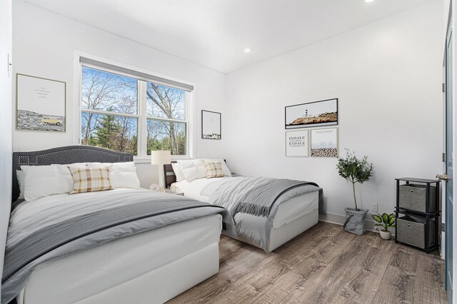 bedroom featuring baseboards, recessed lighting, and wood finished floors