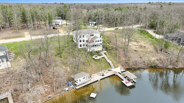 bird's eye view featuring a forest view and a water view