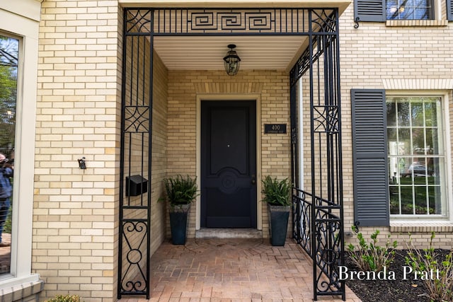 property entrance featuring brick siding