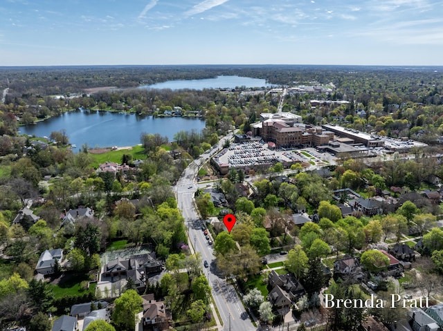 aerial view featuring a water view and a forest view