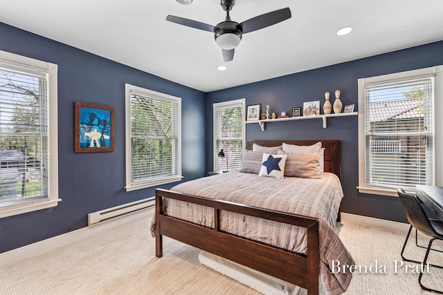 carpeted bedroom featuring baseboards, a baseboard radiator, a ceiling fan, and multiple windows