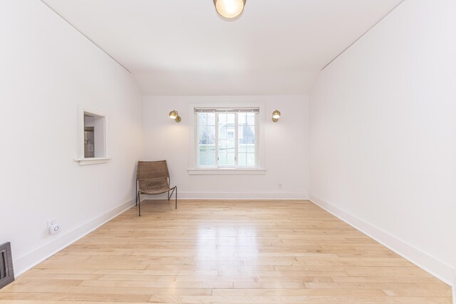 unfurnished room featuring baseboards and wood finished floors