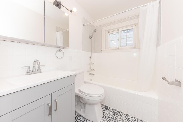bathroom featuring tile walls, tile patterned flooring, shower / bath combo, vanity, and toilet