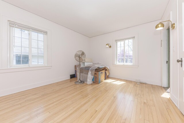 spare room featuring baseboards and hardwood / wood-style floors