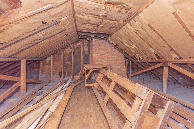 unfinished attic with an upstairs landing