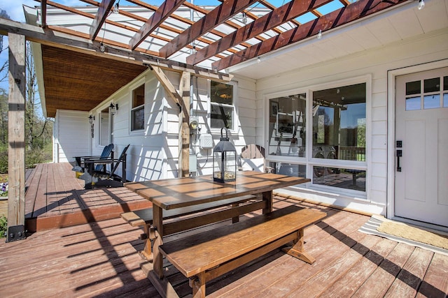 wooden deck featuring a pergola and outdoor dining area