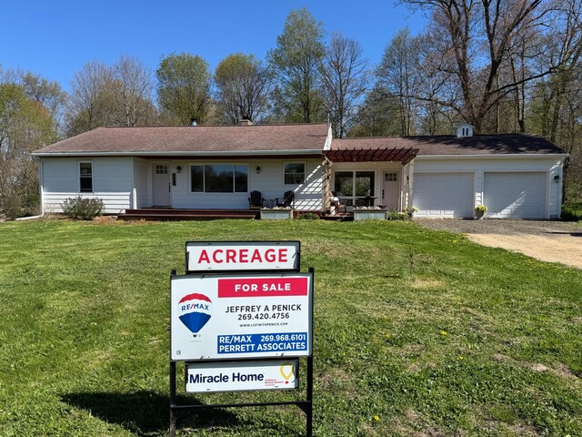view of front of house with a garage, driveway, and a front lawn