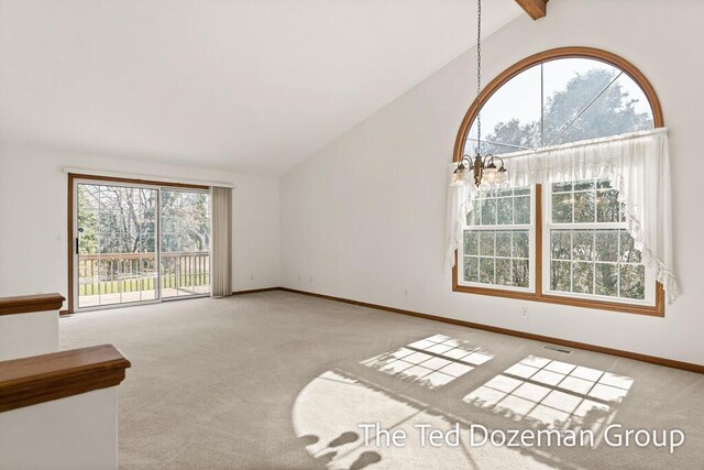 unfurnished living room with carpet flooring, baseboards, visible vents, and vaulted ceiling with beams