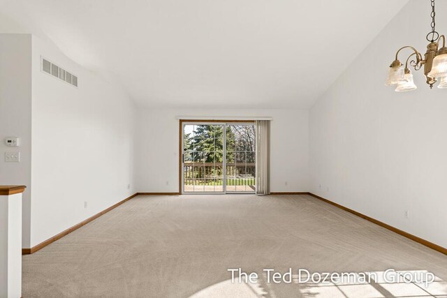 empty room featuring carpet floors, baseboards, a notable chandelier, and visible vents