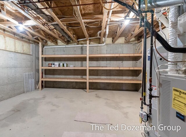 unfinished basement featuring heating unit