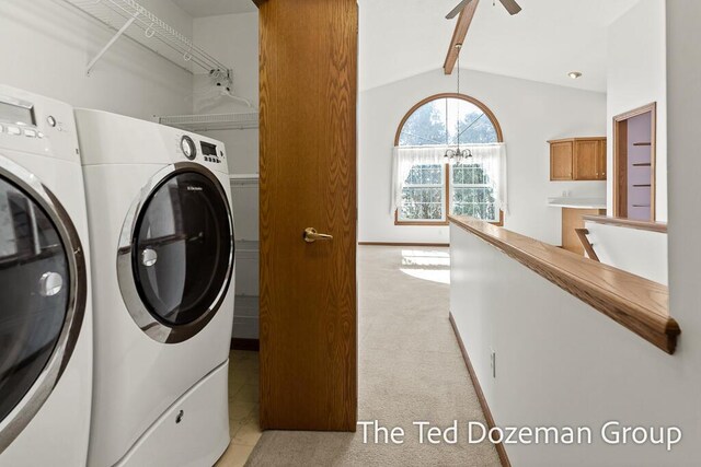 laundry area featuring laundry area, washer and clothes dryer, a ceiling fan, and light carpet