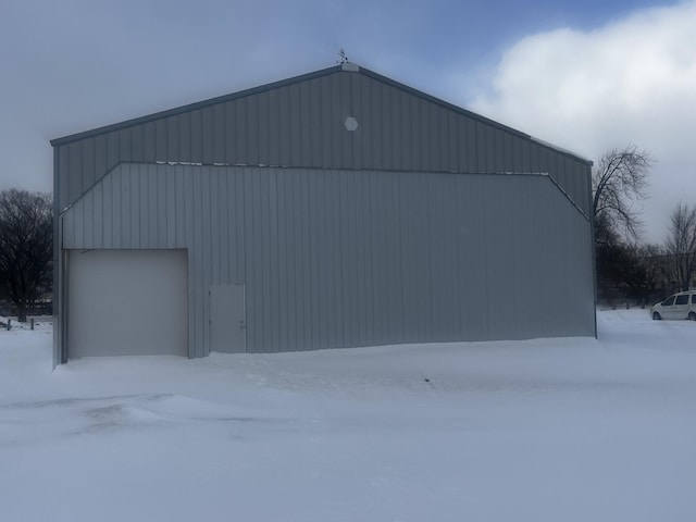snow covered structure featuring an outdoor structure