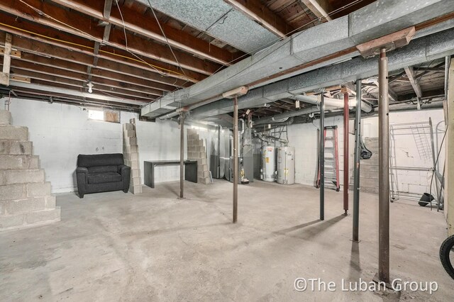 below grade area with heating unit, water heater, and gas water heater