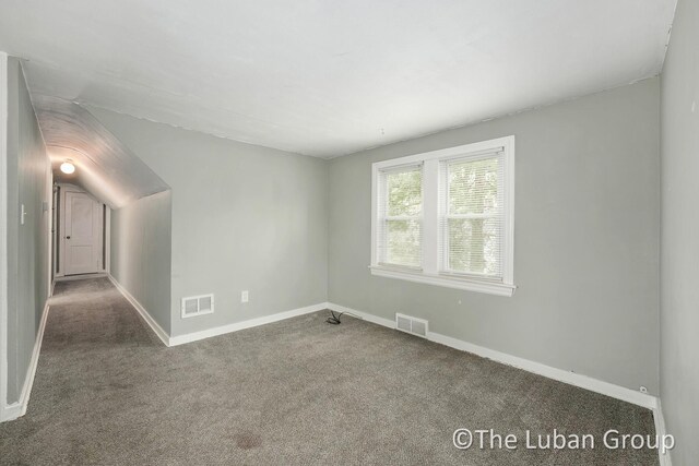 spare room featuring carpet flooring, baseboards, and visible vents