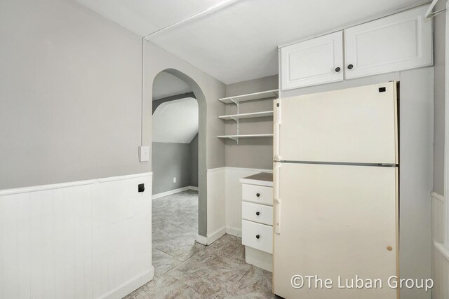 spacious closet with arched walkways