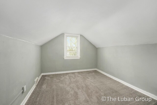 bonus room featuring carpet floors, baseboards, vaulted ceiling, and visible vents