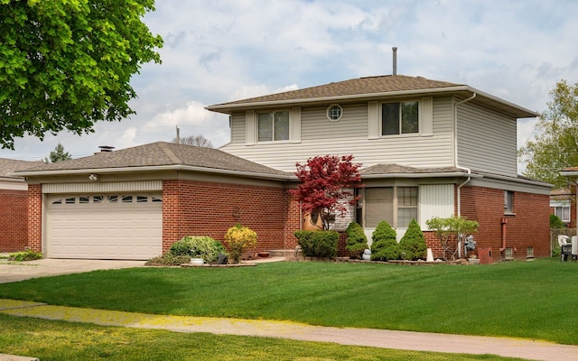 view of front of house with brick siding, driveway, a front yard, and a garage