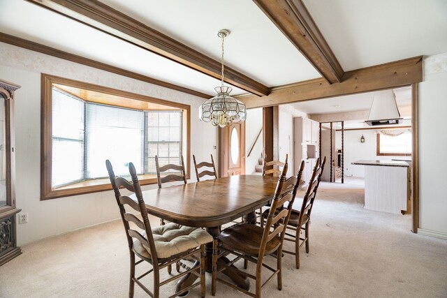 dining space featuring an inviting chandelier, beam ceiling, light carpet, and stairway