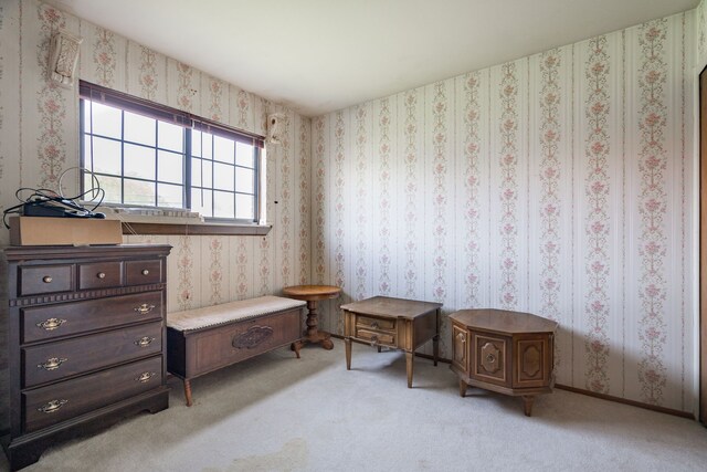 sitting room featuring light carpet