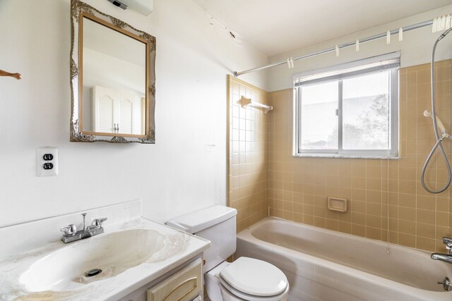 bathroom with toilet, tub / shower combination, and vanity