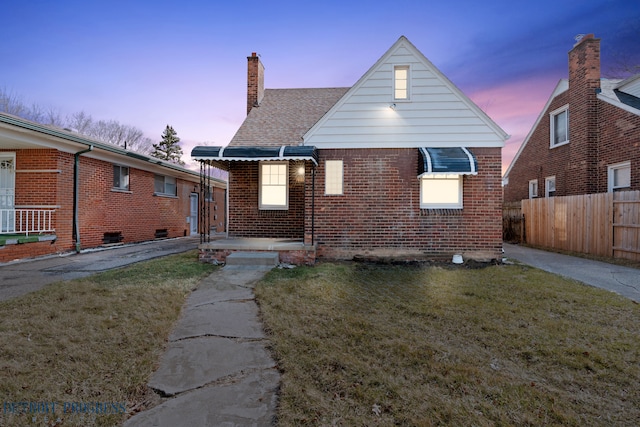 18626 Prevost St, Detroit, MI 48235 - exterior space featuring fence, a shingled roof, brick siding, a chimney, and a yard