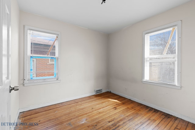 18626 Prevost St, Detroit, MI 48235 - empty room with a healthy amount of sunlight, baseboards, hardwood / wood-style flooring, and visible vents