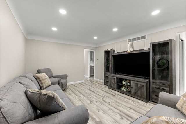 living room with recessed lighting, light wood finished floors, baseboards, and visible vents