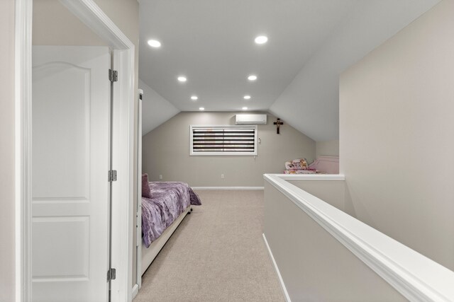 bedroom with light carpet, a wall mounted air conditioner, recessed lighting, baseboards, and vaulted ceiling