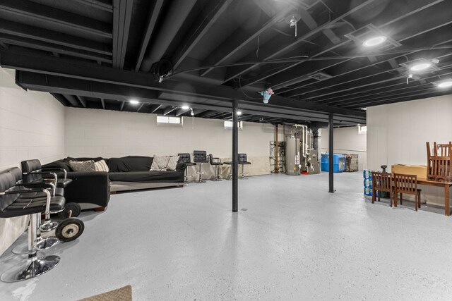 finished basement with concrete block wall and water heater