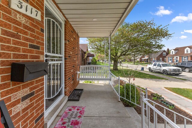 view of patio featuring a porch and a residential view