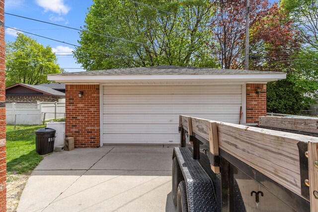 detached garage featuring fence