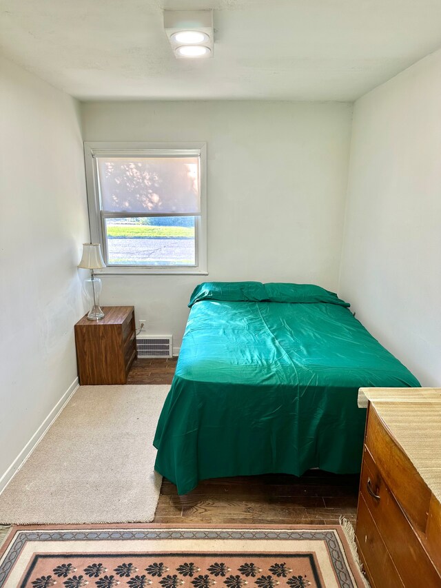 bedroom featuring visible vents and baseboards