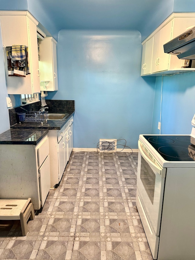 kitchen featuring brick patterned floor, baseboards, white electric range, under cabinet range hood, and a sink