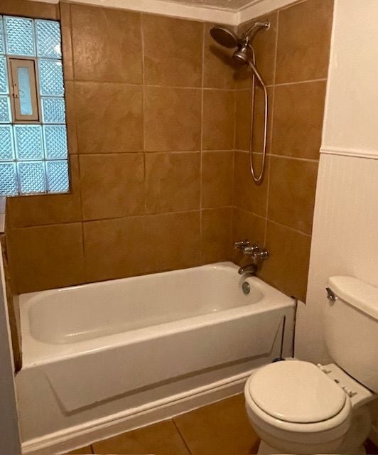 full bathroom featuring toilet, tile patterned flooring, and shower / tub combination