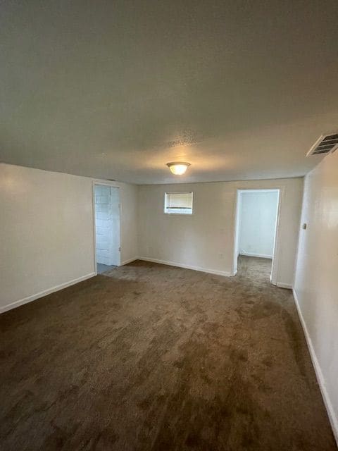 empty room with carpet floors and baseboards