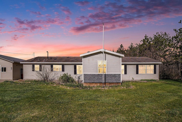 5355 W Remus Rd, Mount Pleasant, MI 48858 - back of house at dusk with a yard