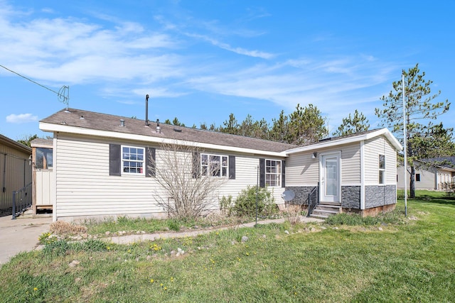 5355 W Remus Rd, Mount Pleasant, MI 48858 - view of front of home with a front lawn, stone siding, and entry steps