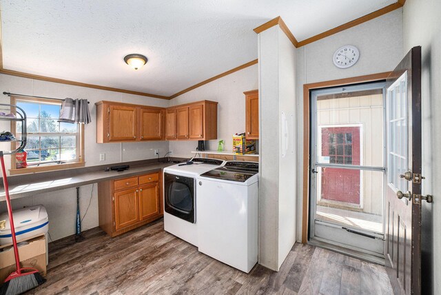 5355 W Remus Rd, Mount Pleasant, MI 48858 - kitchen with crown molding, separate washer and dryer, a textured ceiling, wood finished floors, and vaulted ceiling
