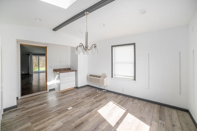 5355 W Remus Rd, Mount Pleasant, MI 48858 - unfurnished dining area featuring baseboards, a wall mounted AC, lofted ceiling with beams, light wood finished floors, and a notable chandelier
