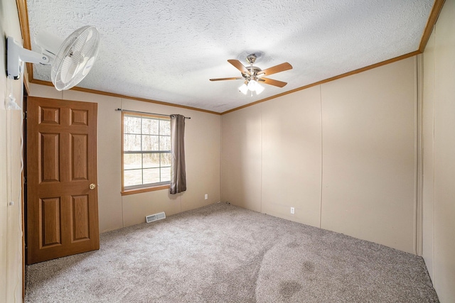 5355 W Remus Rd, Mount Pleasant, MI 48858 - empty room with visible vents, ornamental molding, ceiling fan, a textured ceiling, and carpet flooring