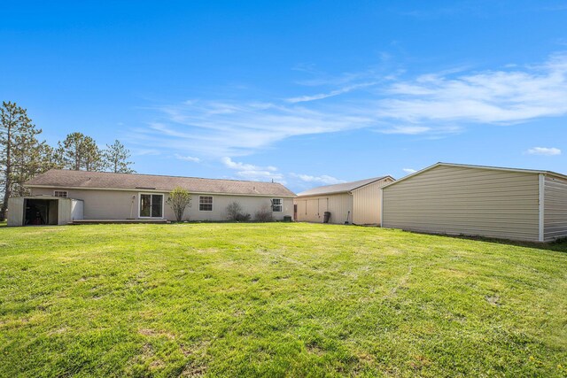 5355 W Remus Rd, Mount Pleasant, MI 48858 - back of house featuring a lawn and an outdoor structure